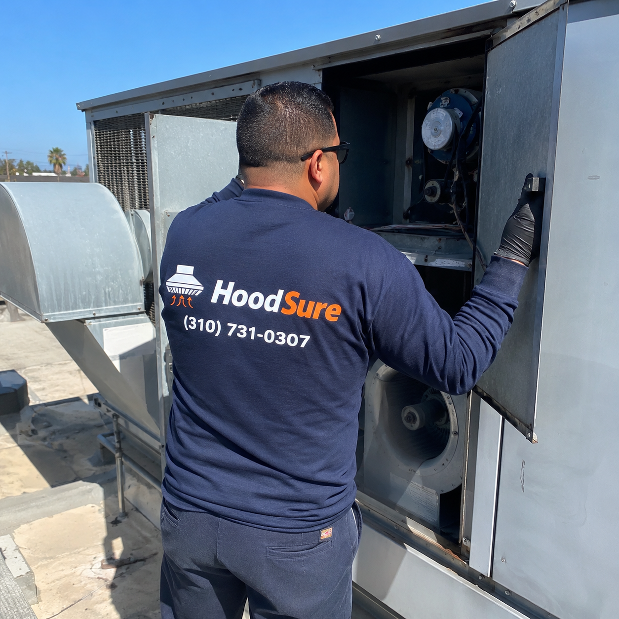 HoodSure technician inspecting rooftop make-up air equipment
